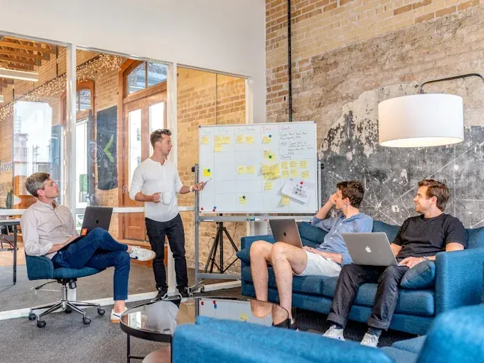 A team meeting around a whiteboard